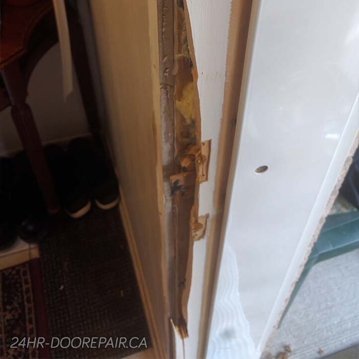 The cracked and split wood of the door frame